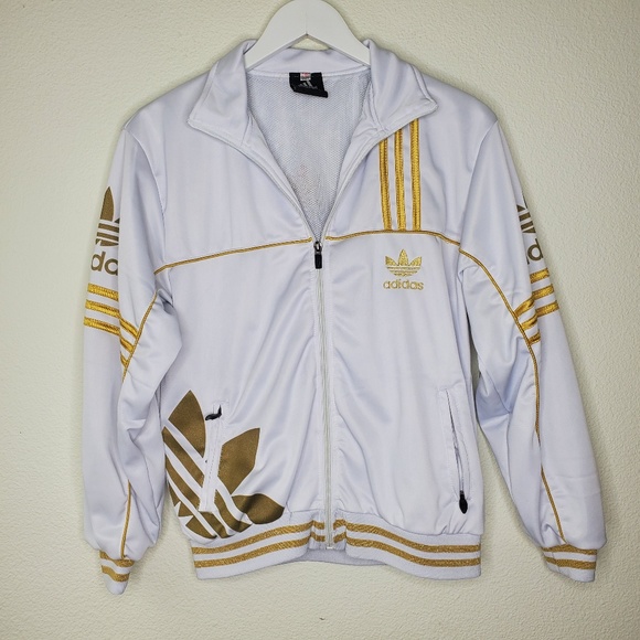 white adidas jacket with gold stripes